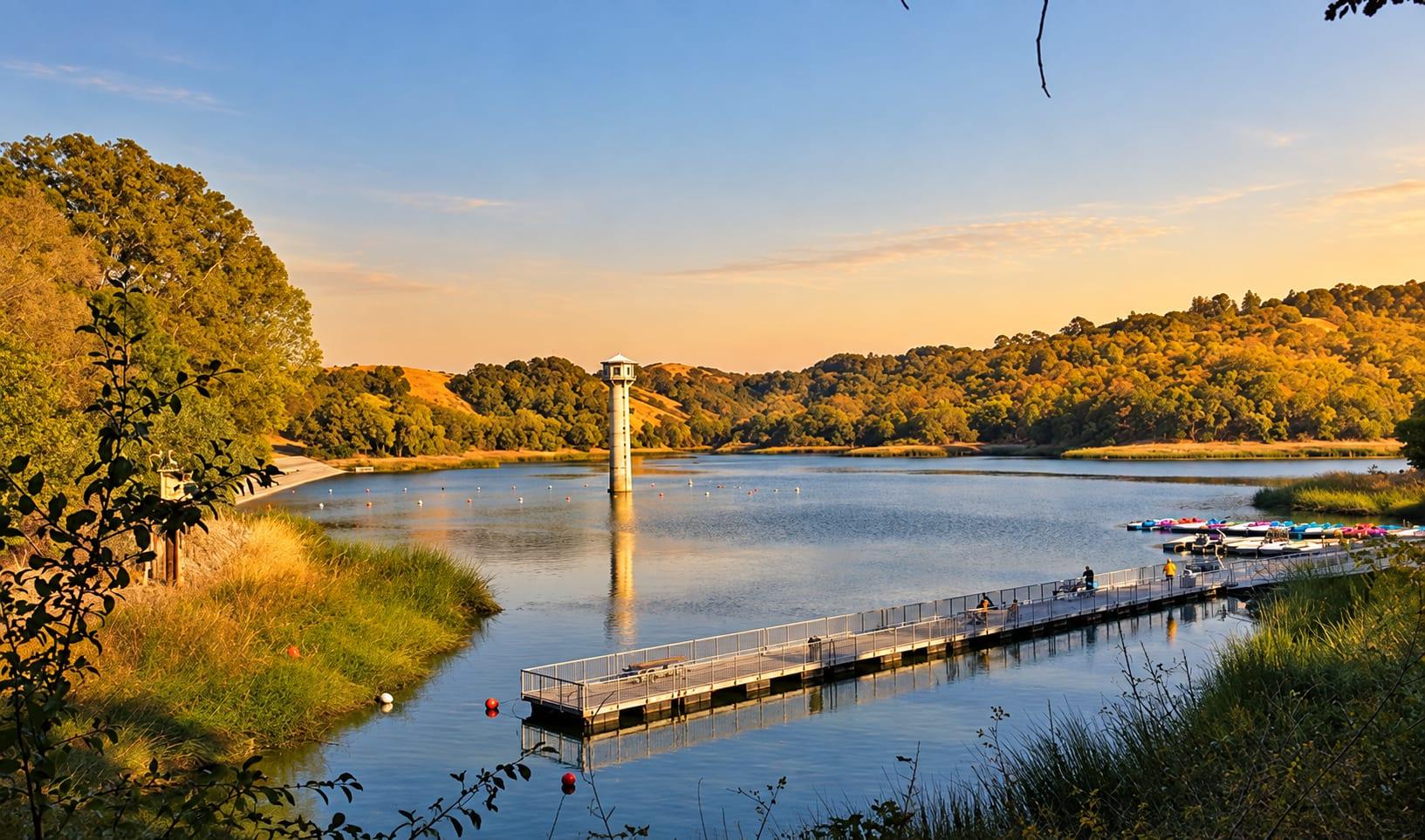 Lafayette Reservoir at golden hour, with its intake tower, boat dock and oak-covered hills